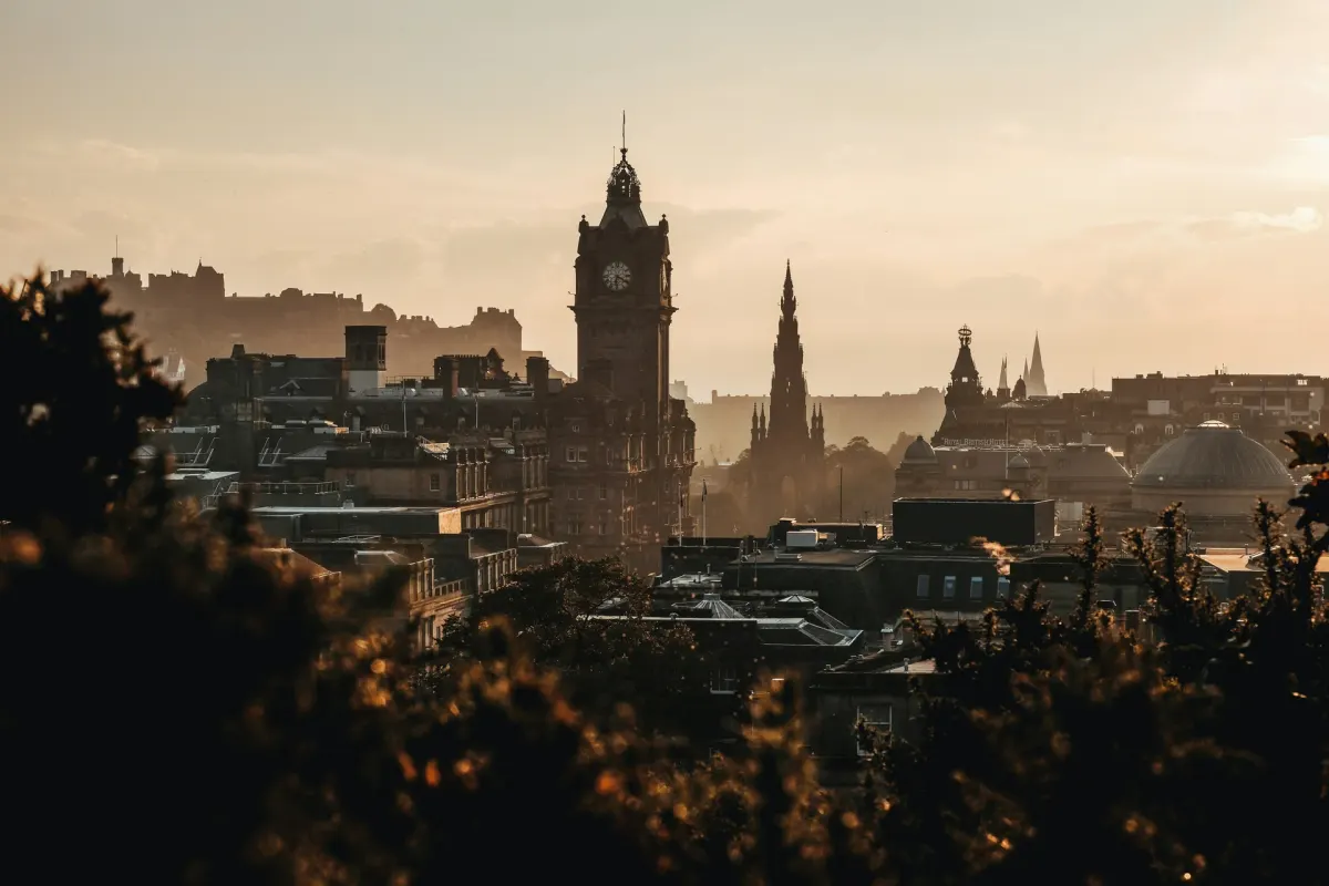 Edinburgh rooftops and the Balmoral clock tower in evening light